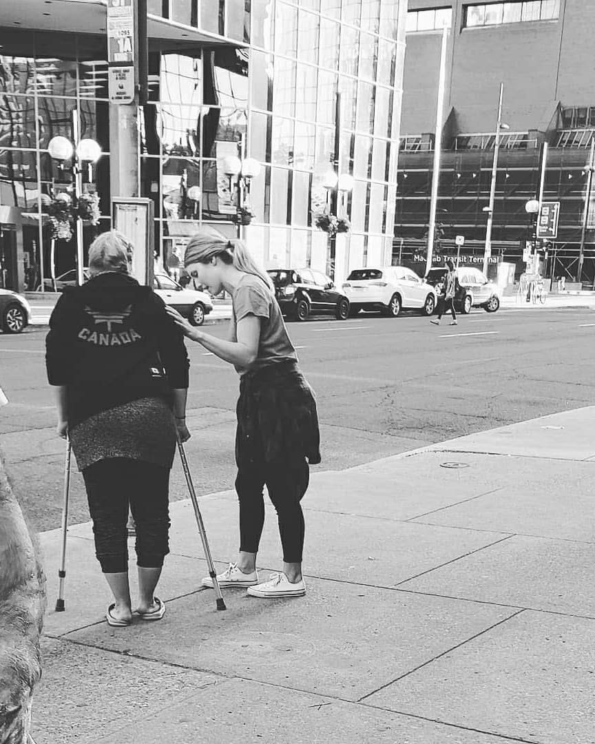 Daniel Ziedins helping someone on the street